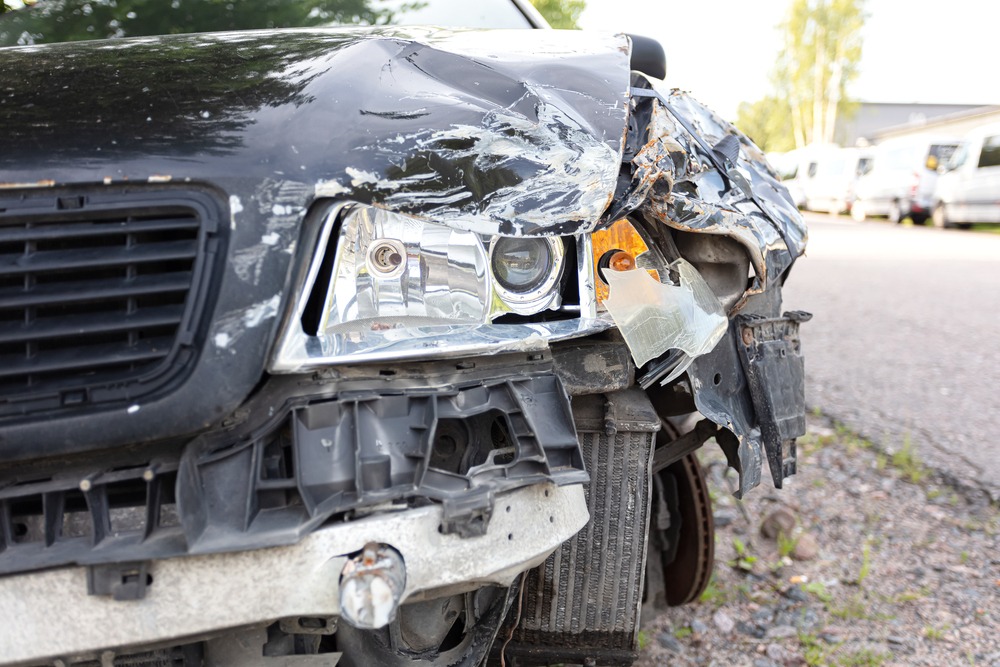 A crashed front end of a car after a car accident. Should I get a lawyer?