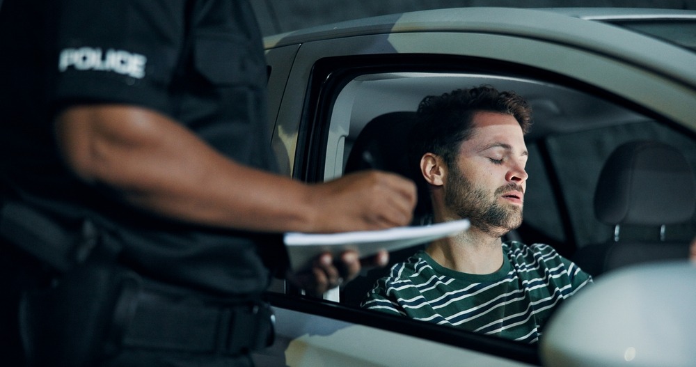 A driver speaking to a police officer during his first DUI stop. Is it worth hiring a lawyer for a first DUI?