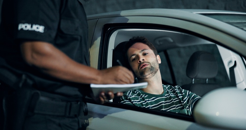 A driver speaking to a police officer during a DUI stop. What happens when you get a DUI in Washington?