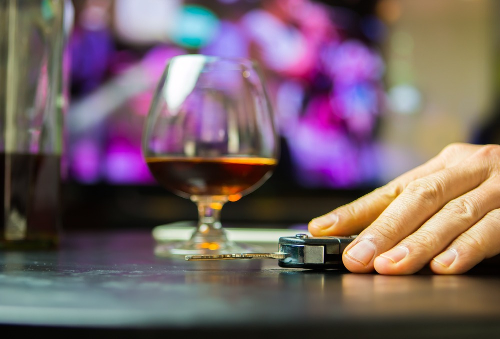 A man holding his keys after drinking in Washington. How much does a DUI cost in Washington?